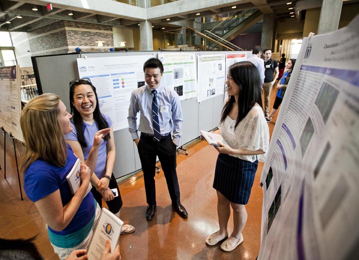 Happy and relieved students sharing posters at Visible Thinking 2014. (Megan Morr, Duke Photo)