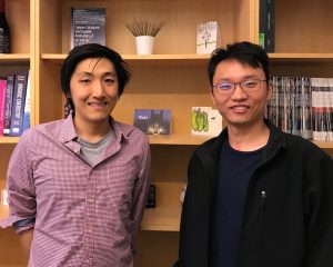 A photo of graduate students Junu Bae and Zijian Zhou in front of a bookshelf.